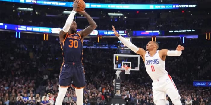 Randle (30) shoots despite the efforts of Clippers guard Russell Westbrook